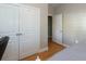 Bedroom with hardwood floors, closet, and an open door to another room at 1025 Riverland Woods Pl # 907, Charleston, SC 29412
