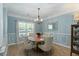Dining room with a round table, upholstered chairs, and elegant chandelier at 1025 Riverland Woods Pl # 907, Charleston, SC 29412