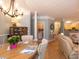 Bright dining room with hardwood floors, a chandelier, and an open layout flowing into the living area at 1025 Riverland Woods Pl # 907, Charleston, SC 29412