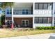 Charming condo with a screened porch, black metal railings, and an American flag at 1025 Riverland Woods Pl # 907, Charleston, SC 29412