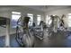 Well-equipped fitness center with cardio machines, weight equipment, and ample natural light at 1025 Riverland Woods Pl # 907, Charleston, SC 29412