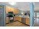 Well-lit kitchen featuring stainless steel appliances, wood cabinets, and hardwood floors at 1025 Riverland Woods Pl # 907, Charleston, SC 29412