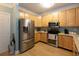 Well-equipped kitchen with stainless steel appliances and wood cabinets at 1025 Riverland Woods Pl # 907, Charleston, SC 29412