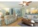 Open-concept living room with a fireplace, ceiling fan, and hardwood floors at 1025 Riverland Woods Pl # 907, Charleston, SC 29412