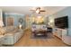 Inviting living room with hardwood floors, a ceiling fan, and views into the adjacent kitchen at 1025 Riverland Woods Pl # 907, Charleston, SC 29412