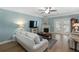 Comfortable living room with a fireplace, ceiling fan, and access to the balcony at 1025 Riverland Woods Pl # 907, Charleston, SC 29412