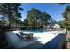 Large community pool with surrounding patio and seating area for residents at 1025 Riverland Woods Pl # 907, Charleston, SC 29412