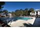 Large community pool surrounded by lush greenery and inviting seating areas at 1025 Riverland Woods Pl # 907, Charleston, SC 29412