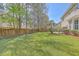 Expansive backyard with lush green lawn and wooden fence, offering privacy and space for outdoor activities at 103 Sago Palm Ct, Summerville, SC 29483