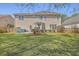 Spacious backyard with a patio, grill, and a well-maintained lawn, perfect for outdoor gatherings at 103 Sago Palm Ct, Summerville, SC 29483