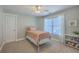 Carpeted bedroom featuring a twin bed, bookshelf, a window with blinds and curtains at 103 Sago Palm Ct, Summerville, SC 29483