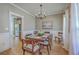 Dining room featuring a chandelier, a dark wood table, and an opening to the kitchen at 103 Sago Palm Ct, Summerville, SC 29483