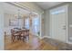 Bright dining room with hardwood floors, wainscoting, a chandelier, and a large dining table at 103 Sago Palm Ct, Summerville, SC 29483