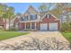 Inviting two-story home with brick accents, a spacious driveway, and a well-maintained front lawn at 103 Sago Palm Ct, Summerville, SC 29483