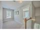 Upstairs hallway with carpeted floor and staircase leading to the next level of the home at 103 Sago Palm Ct, Summerville, SC 29483