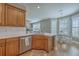 Bright kitchen features wood cabinets, stainless steel appliances, and an open view to a breakfast nook and living space at 103 Sago Palm Ct, Summerville, SC 29483
