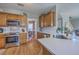 Modern kitchen with stainless steel appliances, wooden cabinets, and a tile backsplash at 103 Sago Palm Ct, Summerville, SC 29483