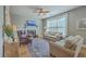 Comfortable living room with fireplace, ceiling fan, and ample natural light at 103 Sago Palm Ct, Summerville, SC 29483