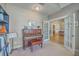 Cozy living area featuring a piano and adjacent dining room through French doors at 103 Sago Palm Ct, Summerville, SC 29483
