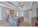 Another angle of main bedroom with a tray ceiling, two windows, a ceiling fan, and dark wood furniture at 103 Sago Palm Ct, Summerville, SC 29483