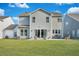 View of the home's backyard featuring a lawn and a concrete patio with furniture for outdoor relaxation at 107 Willett Ln, Summerville, SC 29486