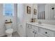 Bright bathroom with a window, white vanity, and framed floral art at 107 Willett Ln, Summerville, SC 29486