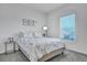 Bright bedroom with stylish floral bedding, accent table, and serene window view at 107 Willett Ln, Summerville, SC 29486