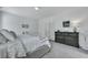 View of bedroom with decor art, dark dresser, and a white fan at 107 Willett Ln, Summerville, SC 29486