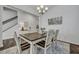 Cozy dining room with wood-look floors, a stylish chandelier, and a staircase to the upper level at 107 Willett Ln, Summerville, SC 29486