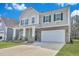 Attractive two-story home with a spacious driveway, a two-car garage, and manicured landscaping at 107 Willett Ln, Summerville, SC 29486