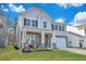 Charming two-story home with a brick and siding facade, a covered porch, and a well-manicured front lawn at 107 Willett Ln, Summerville, SC 29486