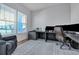 Bright home office with large windows, a spacious desk, and comfortable seating area for work or relaxation at 107 Willett Ln, Summerville, SC 29486