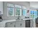 Kitchen featuring a stainless steel dishwasher, undermount sink, and large windows offering natural light at 107 Willett Ln, Summerville, SC 29486