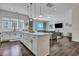 Stylish kitchen island with white cabinetry, a marble countertop, and a view into the living area at 107 Willett Ln, Summerville, SC 29486