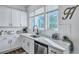 Kitchen featuring a stainless steel dishwasher, undermount sink, and large windows offering natural light at 107 Willett Ln, Summerville, SC 29486