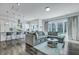 Open-concept living room flowing to a kitchen with island and slider doors to the backyard at 107 Willett Ln, Summerville, SC 29486