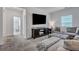 Cozy living room showcasing a comfortable gray sectional sofa, TV, and adjacent bathroom at 107 Willett Ln, Summerville, SC 29486