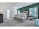 Main bedroom featuring a tufted headboard, ensuite bathroom, and floral curtains at 107 Willett Ln, Summerville, SC 29486