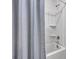 Clean bathroom shower with white fixtures and textured shower curtain at 107 Willett Ln, Summerville, SC 29486