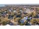 Wide aerial view of a residential area with lush trees and partial views of a city skyline and coastal waterways at 108 Rose Ln, Mount Pleasant, SC 29464