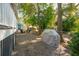 Spacious backyard showcasing an outdoor seating area and a grill under the shade of mature trees at 108 Rose Ln, Mount Pleasant, SC 29464
