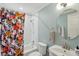 Cozy bathroom with floral shower curtain, subway tiles, and round mirror at 108 Rose Ln, Mount Pleasant, SC 29464