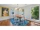 Bright dining room with wood floors, stylish chandelier, and a vibrant art piece at 108 Rose Ln, Mount Pleasant, SC 29464