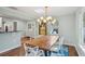 Stylish dining area showcases a modern chandelier, artwork, and seamless transition to the kitchen at 108 Rose Ln, Mount Pleasant, SC 29464