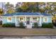 Charming light-blue single story home with a covered front porch and manicured lawn at 108 Rose Ln, Mount Pleasant, SC 29464