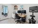 Bright home office with wood desk, modern decor, dual monitors, exercise bike and ample natural light at 108 Rose Ln, Mount Pleasant, SC 29464