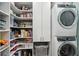 Functional laundry room features shelving, storage, and modern washer/dryer units at 108 Rose Ln, Mount Pleasant, SC 29464