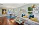 Inviting living area featuring stylish decor, hardwood floors, and seamless flow to dining space at 108 Rose Ln, Mount Pleasant, SC 29464