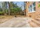 Large backyard with a mature brick home, fence, patio and mature trees and landscaping at 109 Buckingham Ave, Summerville, SC 29485