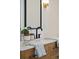 Bathroom counter with neutral finish, featuring a dark faucet, and framed mirror at 109 Buckingham Ave, Summerville, SC 29485